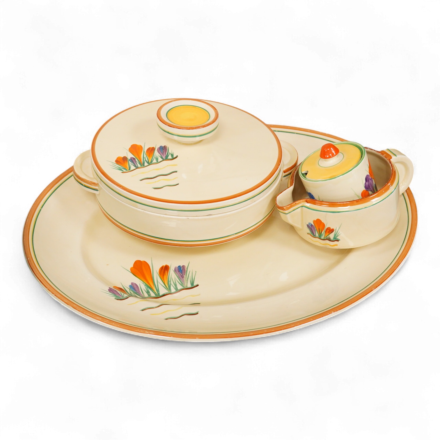 A Clarice Cliff ‘crocus pattern’ tureen and cover, jug, honey pot with cover and an oval meat platter - 43cm wide